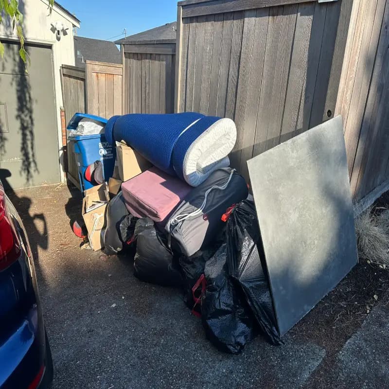 A messy junk pile filled with disposable items and mattresses in Seattle before junk removal