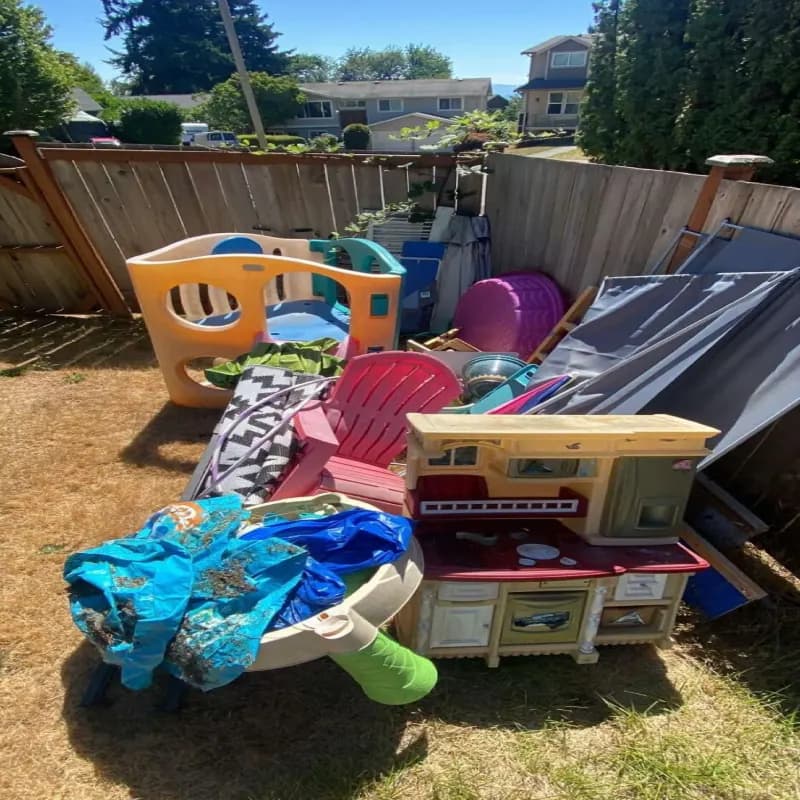 A messy yard full of items to be discarded in Seattle before junk removal